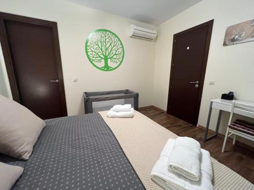 a bedroom with a bed and a tree on the wall at Apartamento El Mirador de La Farga in Arbúcies