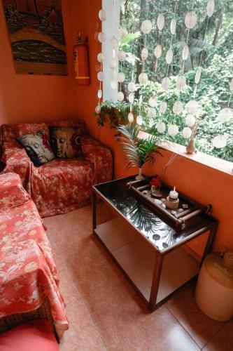 a living room with a couch and a coffee table at Cozy Dream Apartment in Anjuna