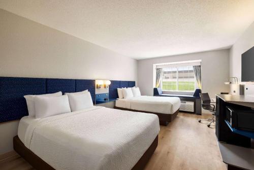a hotel room with two beds and a window at Microtel Inn & Suites by Wyndham New Ulm in New Ulm