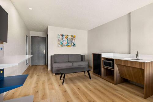 a living room with a couch and a kitchen at Microtel Inn & Suites by Wyndham New Ulm in New Ulm
