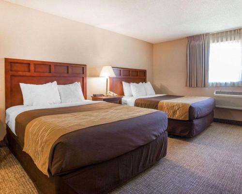 a hotel room with two beds and a window at Quality Inn Kirkland in Kirkland