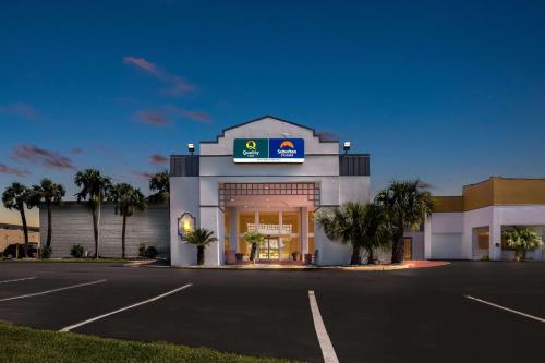 a gas station with a sign on the front of it at Suburban Studios Slidell I-10 in Slidell