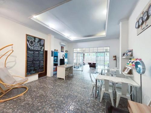 a dining room with a table and chairs and a chalkboard at OstiC House in Yogyakarta