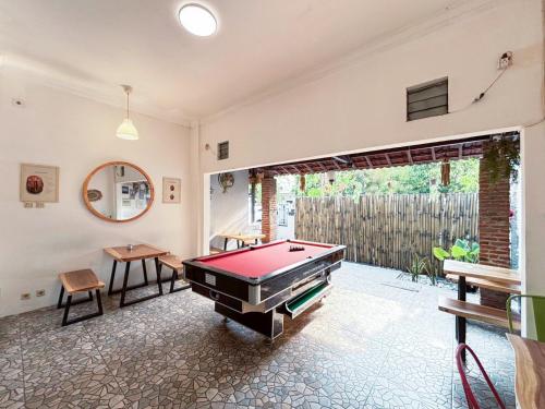 a living room with a pool table in it at OstiC House in Yogyakarta