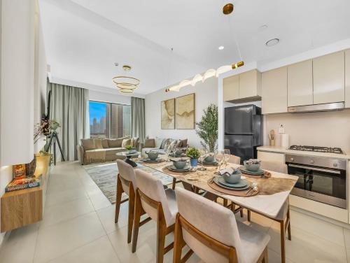 a kitchen and living room with a table and chairs at Premium Two-Bedroom Apartment with Private Balcony & Full Burj Khalifa Views by Al Fannan Holiday Homes in Dubai