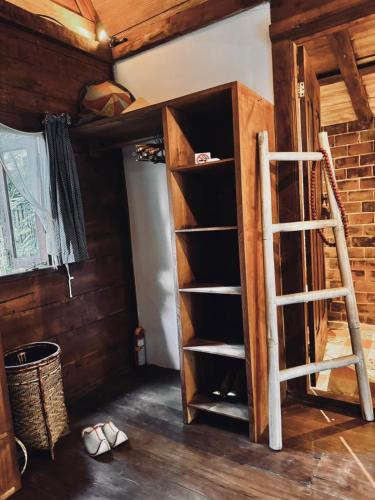 a book shelf in a room with a ladder at Resort JUNGLEROOM Canggu in Canggu