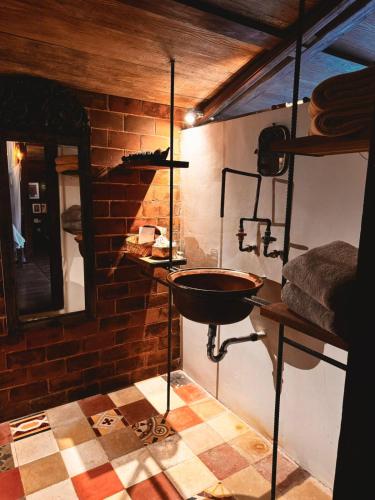 a room with a sink and a brick wall at Resort JUNGLEROOM Canggu in Canggu