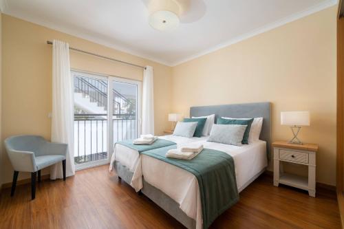 a bedroom with a large bed and a window at Cabanas de Tavira Family Apartment in Cabanas de Tavira