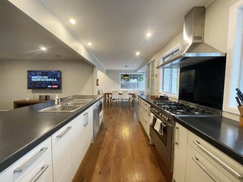 a kitchen with a sink and a stove top oven at New painted 5 bdms spacious house close to the Base in Hamilton