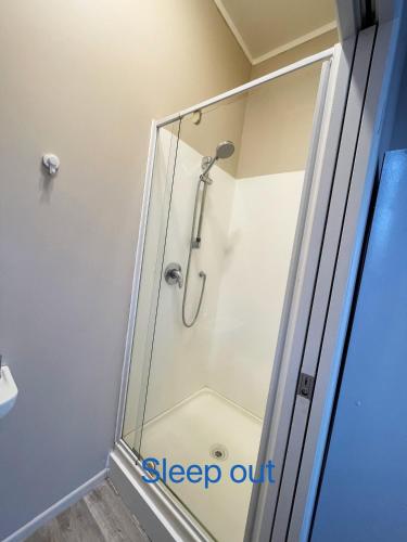 a shower with a glass shower stall in a bathroom at New painted 5 bdms spacious house close to the Base in Hamilton