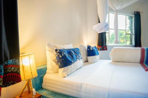 Postel nebo postele na pokoji v ubytování Dan Stam Hotel