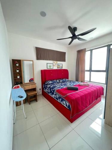 a bedroom with a red bed and a ceiling fan at Cozy kenwingston platz kl 2-5pax 2BR&2BR Klcc view pakin netflx 3705A in Kuala Lumpur