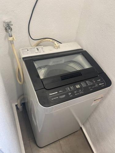 a toaster oven sitting in a corner of a wall at Cozy kenwingston platz kl 2-5pax 2BR&2BR Klcc view pakin netflx 3705A in Kuala Lumpur