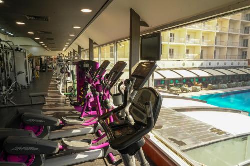 a row of exercise bikes lined up next to a swimming pool at فندق بغداد Baghdad International Hotel in Baghdad