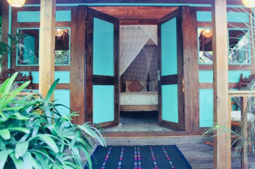 an open door into a house with a rug at Resort JUNGLEROOM Canggu in Canggu