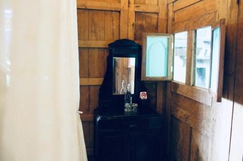 a wooden room with a mirror and a dresser at Resort JUNGLEROOM Canggu in Canggu