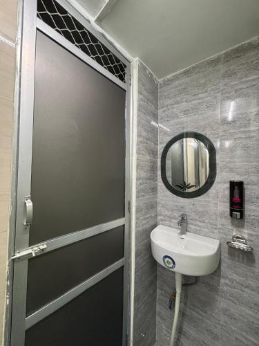 a bathroom with a sink and a mirror at Shree Balaji Comfort - Free Parking in Varanasi