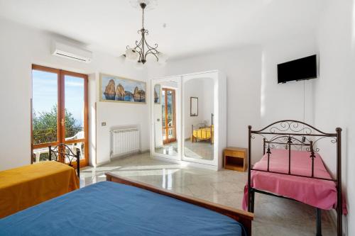 a bedroom with a bed and a tv on a wall at La Vista Sul Golfo in Massa Lubrense