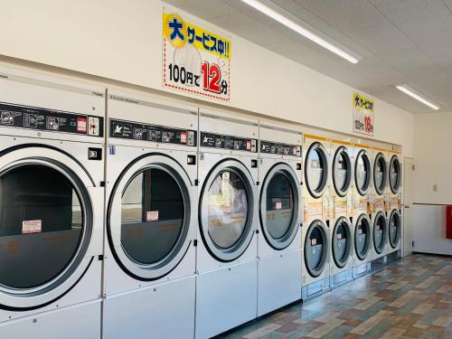 a row of washing machines in a store at Village BFH in Omura