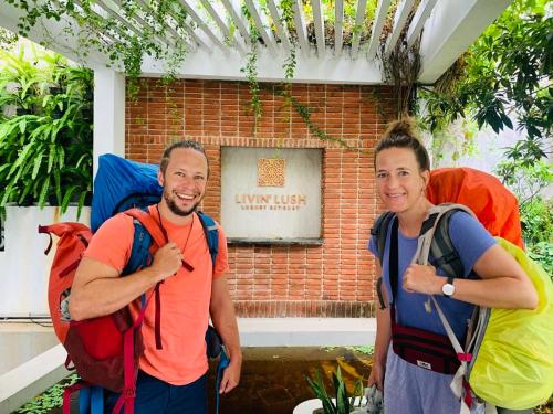 two people with backpacks standing in front of a building at Livin Lush Luxury Retreat in Anuradhapura