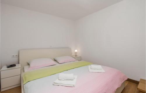 a bedroom with a bed with two towels on it at 3 Bedroom Cozy Home In Krk in Krk