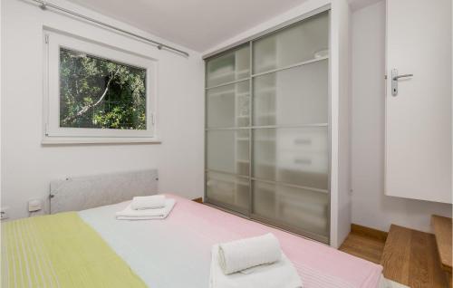 a white room with a bed and a window at 3 Bedroom Cozy Home In Krk in Krk