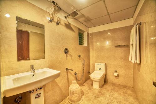 a bathroom with a sink and a toilet at Hotel Visa Inn 4kms from Airport l Free Airport pickup & drop 24x7 in Bengaluru