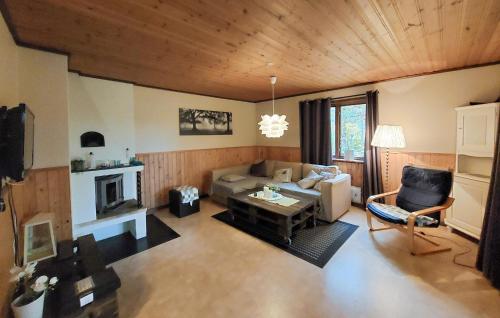 a living room with a couch and a table at 2 Bedroom Stunning Home In Lönashult in Lönashult