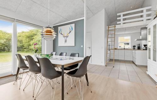a dining room with a table and chairs at 3 Bedroom Beautiful Home In Nexø in Neksø