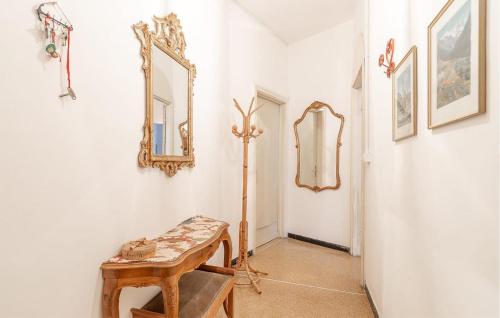 a hallway with a table and a mirror on the wall at Stunning Apartment In Bogliasco With Kitchen in Bogliasco