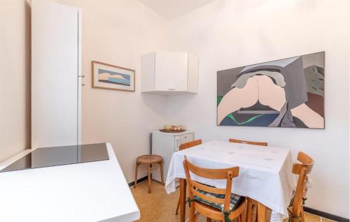 a dining room with a white table and chairs at Stunning Apartment In Bogliasco With Kitchen in Bogliasco