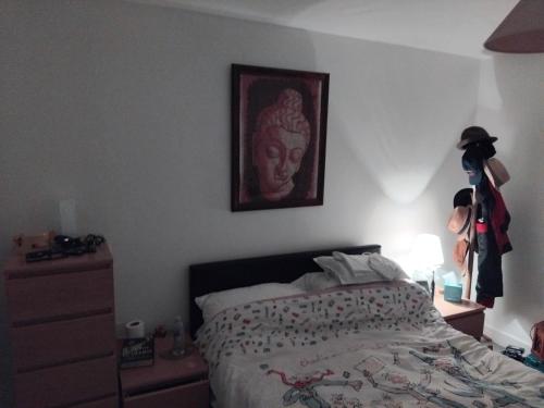a bedroom with a bed and a picture of a woman at Tower Bridge - Saint Katherine's Dock in London