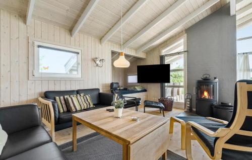 a living room with a couch and a table at Stunning Home In Ringkøbing With Sauna in Ringkøbing