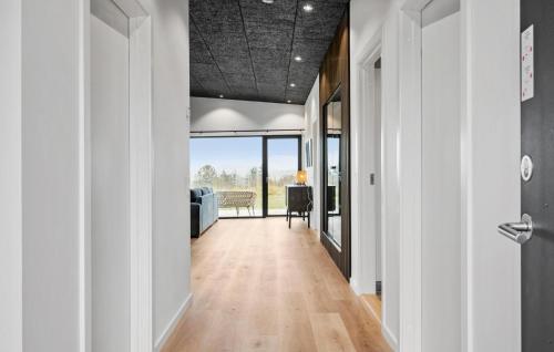 a hallway with white walls and wood floors and a ceiling at 3 Bedroom Stunning Home In Løgstrup in Løgstrup