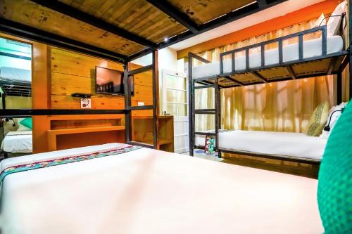 a bedroom with two bunk beds in a room at The Bunksters Mcleodganj, Dharmkot in McLeod Ganj