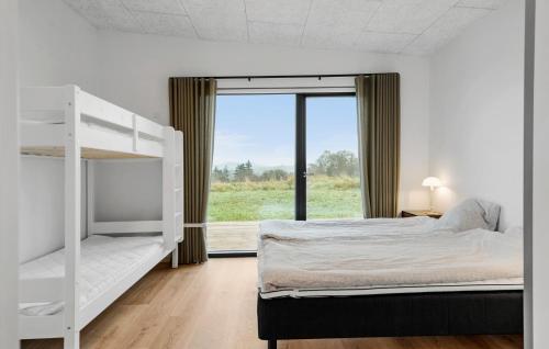a bedroom with a bunk bed and a window at 3 Bedroom Stunning Home In Løgstrup in Løgstrup