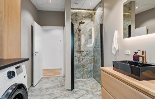 a bathroom with a sink and a shower at 3 Bedroom Stunning Home In Løgstrup in Løgstrup