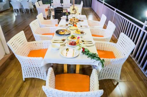 a table with plates of food on it in a restaurant at The Bunksters Mcleodganj, Dharmkot in McLeod Ganj
