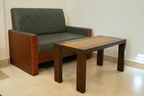 a chair and a table in a room at The Sanihara Hotel & Resort in Vythiri