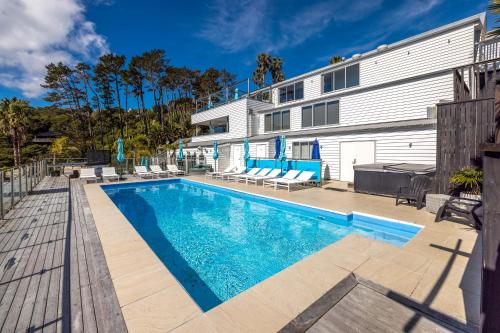 a swimming pool in front of a building at 2 Levels of Magnificient Sea Views in Palm Beach