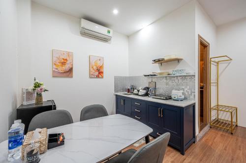 a kitchen with a table and chairs in a room at Palas House By Cozrum in Ho Chi Minh City