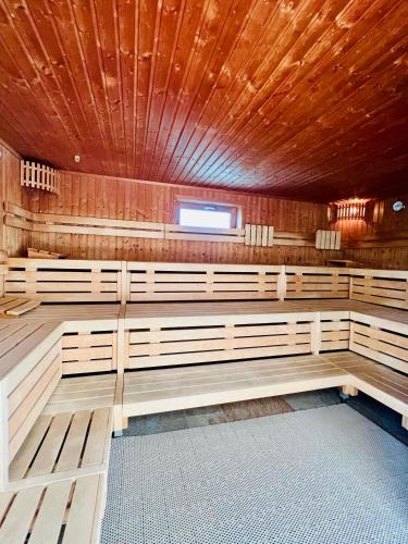 a sauna with wooden benches and a window at Ferienwohnung Wolkenfrei mit Pool und Sauna in Scheidegg