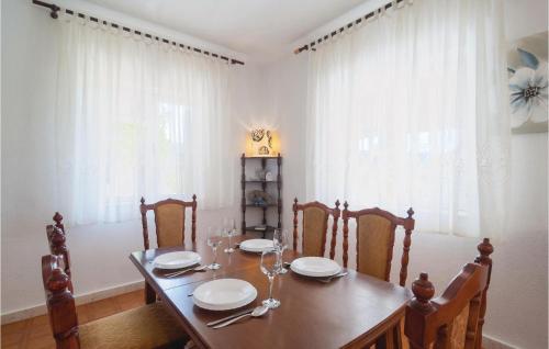 a dining room with a wooden table and chairs at Lovely Home In Pucisca With Jacuzzi in Pučišća