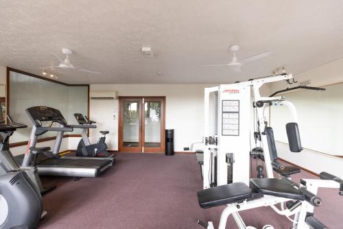a gym with treadmills and elliptical machines at Aqua on the Edge in Airlie Beach