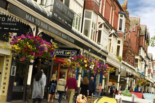 a group of people walking down a busy city street at Edendale House in Southport