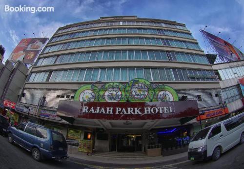 a large building with cars parked in front of it at Rajah Park Hotel by Hiverooms in Cebu City