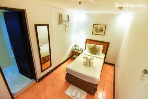 a bedroom with a bed with two stuffed animals on it at Rajah Park Hotel by Hiverooms in Cebu City