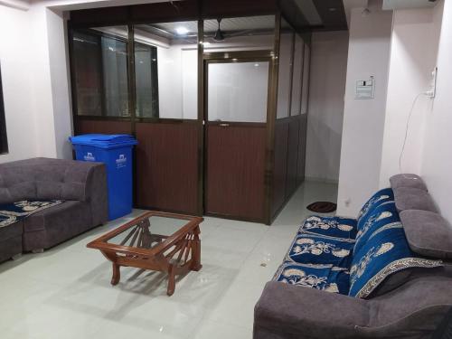 a living room with a couch and a coffee table at Hotel Town Pride , Ganpatipule in Ganpatipule