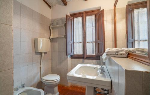 a bathroom with a toilet and a sink at Villa I Cedri in Santa Lucia