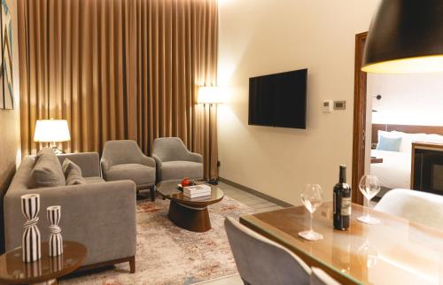 a living room with a couch and a table at Kertel Suites Kinshasa in Kinshasa